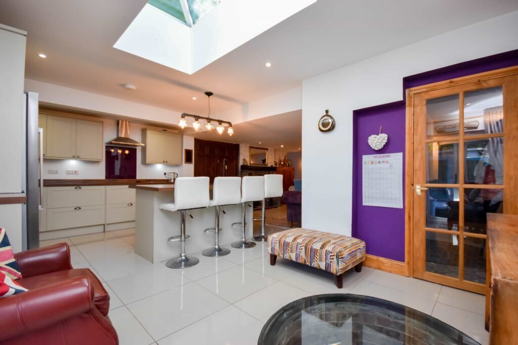 A quirky 1824 cottage in Penkhull priced at 410000 pounds features exposed beams modern spaces and a restored glass covered water well offering rare historic charm today.