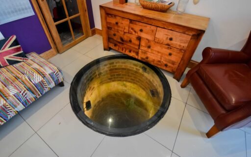 A quirky 1824 cottage in Penkhull priced at 410000 pounds features exposed beams modern spaces and a restored glass covered water well offering rare historic charm today.