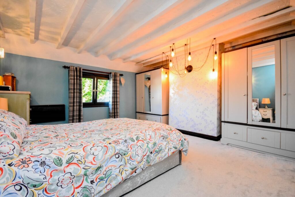 A quirky 1824 cottage in Penkhull priced at 410000 pounds features exposed beams modern spaces and a restored glass covered water well offering rare historic charm today.