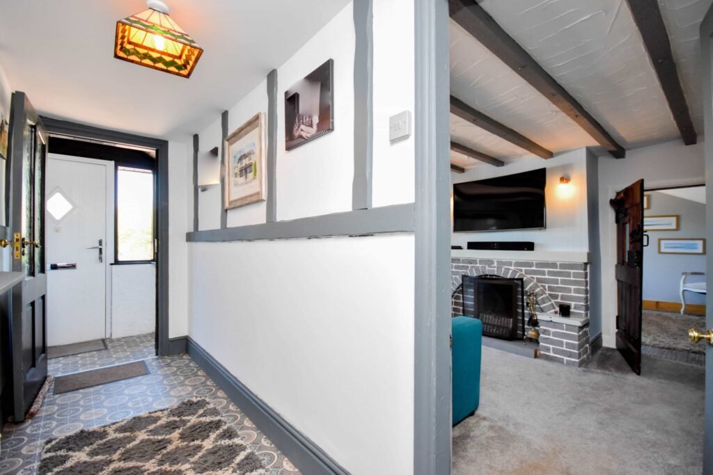 A quirky 1824 cottage in Penkhull priced at 410000 pounds features exposed beams modern spaces and a restored glass covered water well offering rare historic charm today.