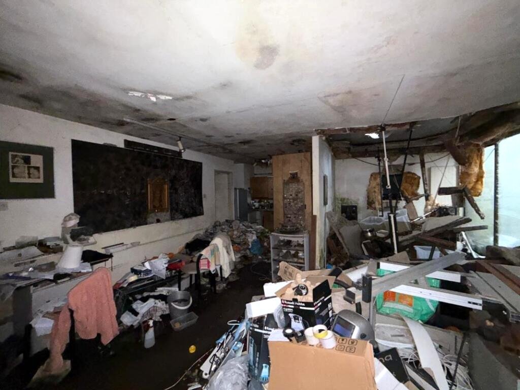 Overgrown Camden Mews home with collapsing interiors and a hidden car is listed for 925k promising redevelopment potential despite its rundown state and stunned locals.
