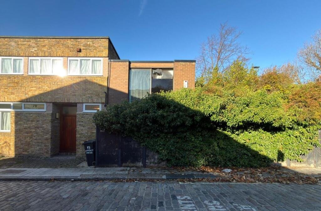 Overgrown Camden Mews home with collapsing interiors and a hidden car is listed for 925k promising redevelopment potential despite its rundown state and stunned locals.