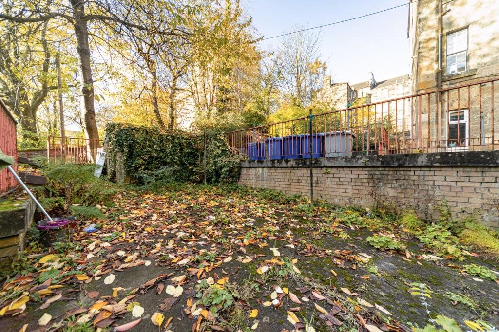 A £99,000 Glasgow flat has hit the market with an unusual twist — the double bed is inside the kitchen, opposite the oven and washing machine, creating a truly quirky layout.