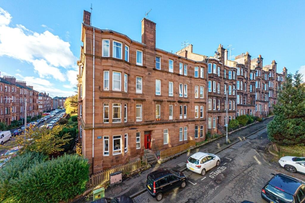 A £99,000 Glasgow flat has hit the market with an unusual twist — the double bed is inside the kitchen, opposite the oven and washing machine, creating a truly quirky layout.