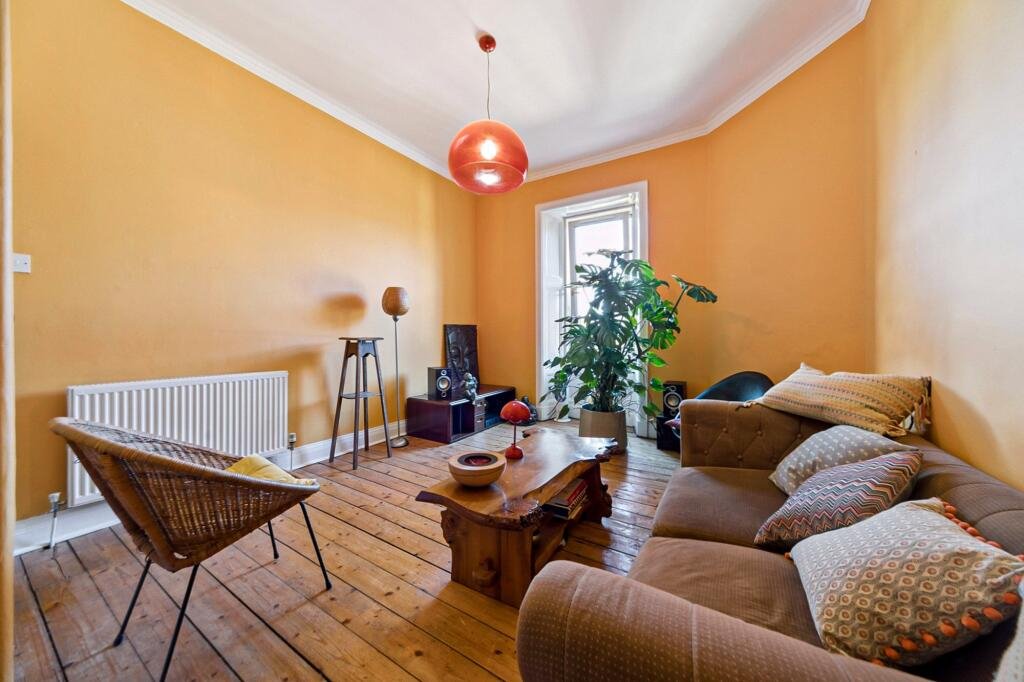 A £99,000 Glasgow flat has hit the market with an unusual twist — the double bed is inside the kitchen, opposite the oven and washing machine, creating a truly quirky layout.