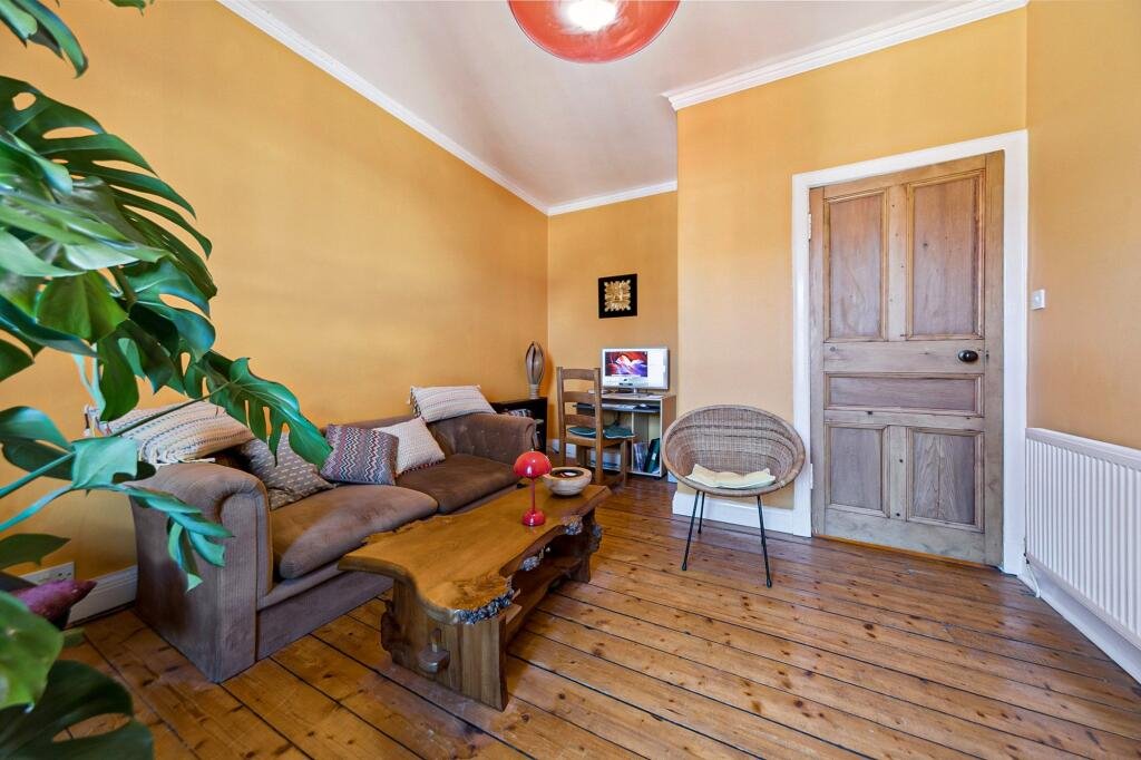 A £99,000 Glasgow flat has hit the market with an unusual twist — the double bed is inside the kitchen, opposite the oven and washing machine, creating a truly quirky layout.