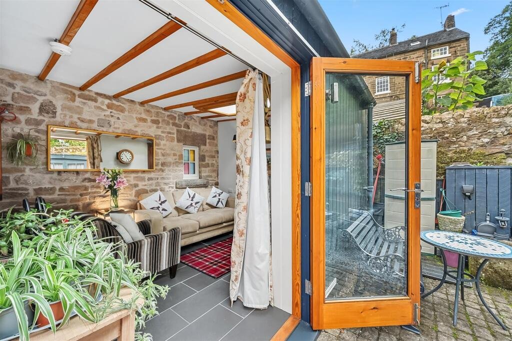 A tiny stone home in Wirksworth priced at 225000 pounds sparks debate as its shed like look contrasts with its modern interior parking space and holiday let potential today.
