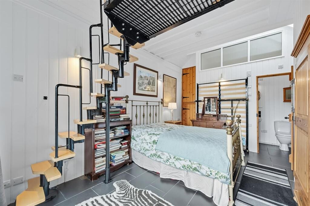 A tiny stone home in Wirksworth priced at 225000 pounds sparks debate as its shed like look contrasts with its modern interior parking space and holiday let potential today.