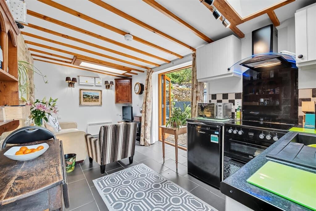 A tiny stone home in Wirksworth priced at 225000 pounds sparks debate as its shed like look contrasts with its modern interior parking space and holiday let potential today.