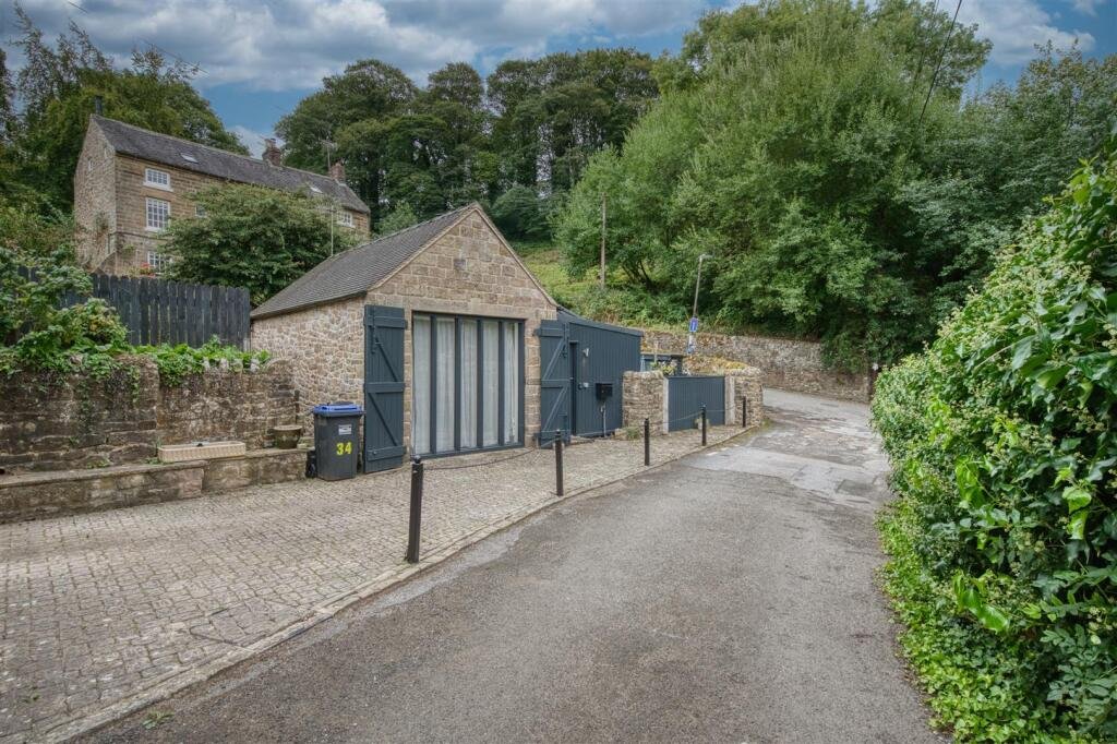 A tiny stone home in Wirksworth priced at 225000 pounds sparks debate as its shed like look contrasts with its modern interior parking space and holiday let potential today.