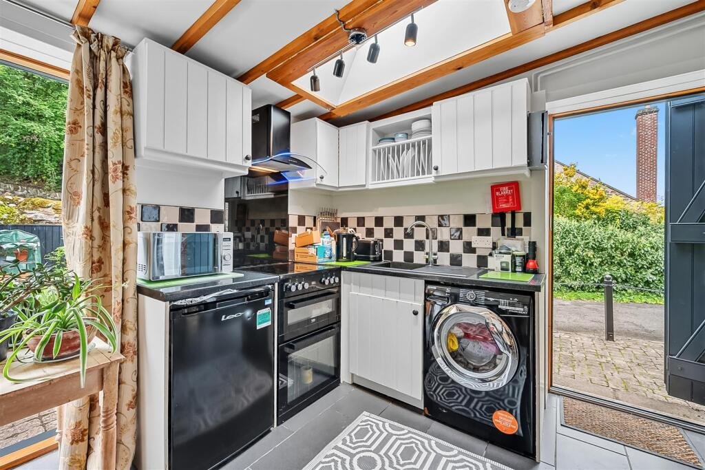 A tiny stone home in Wirksworth priced at 225000 pounds sparks debate as its shed like look contrasts with its modern interior parking space and holiday let potential today.