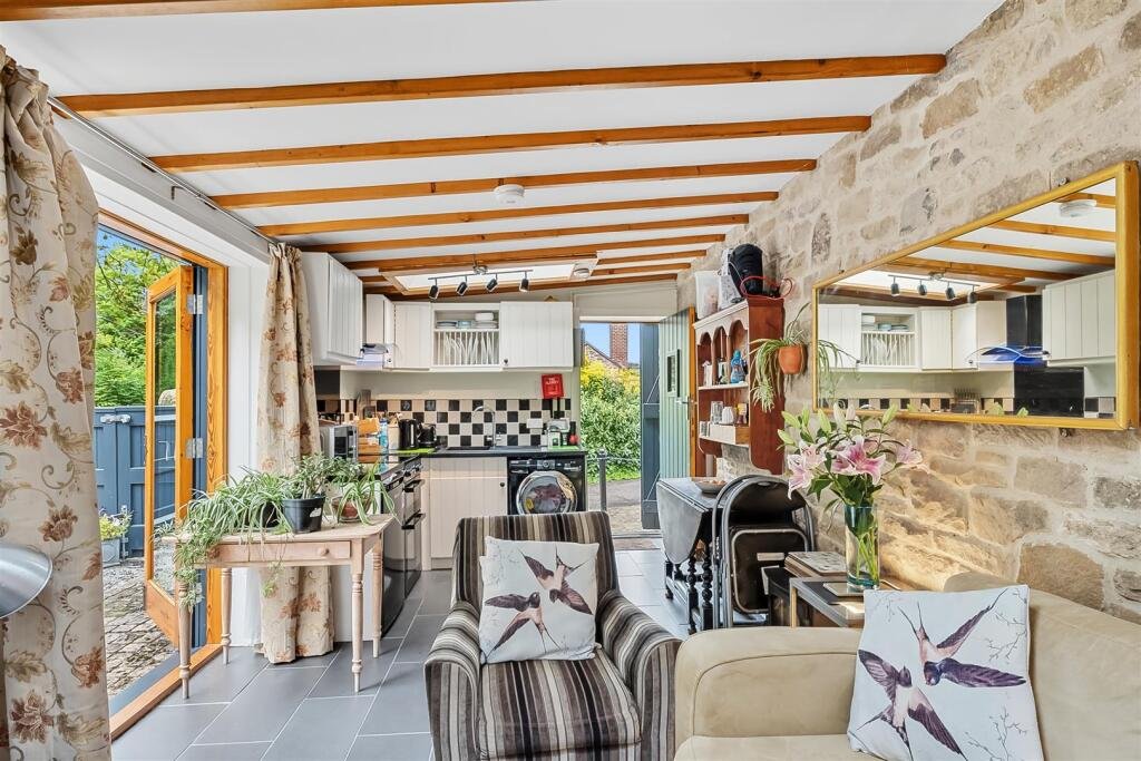 A tiny stone home in Wirksworth priced at 225000 pounds sparks debate as its shed like look contrasts with its modern interior parking space and holiday let potential today.