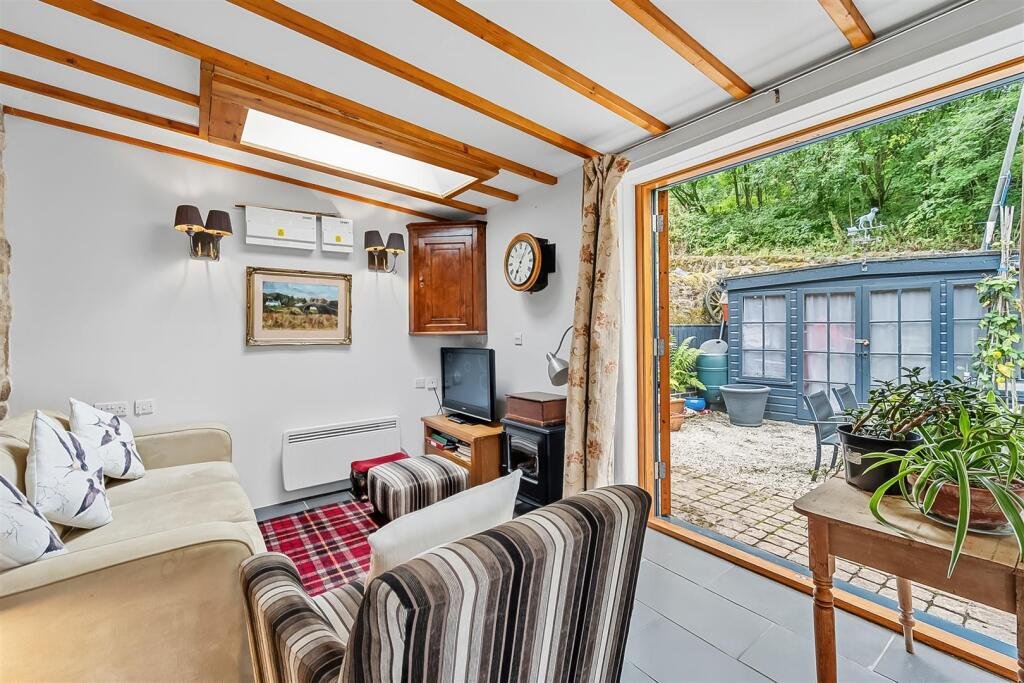 A tiny stone home in Wirksworth priced at 225000 pounds sparks debate as its shed like look contrasts with its modern interior parking space and holiday let potential today.