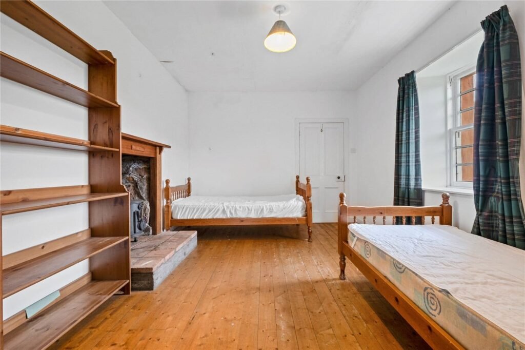 A four-bedroom stone cottage near Loch Torridon is for sale at £550,000, offering nine acres of land, rustic charm, and a private seven-acre island in the Scottish Highlands.