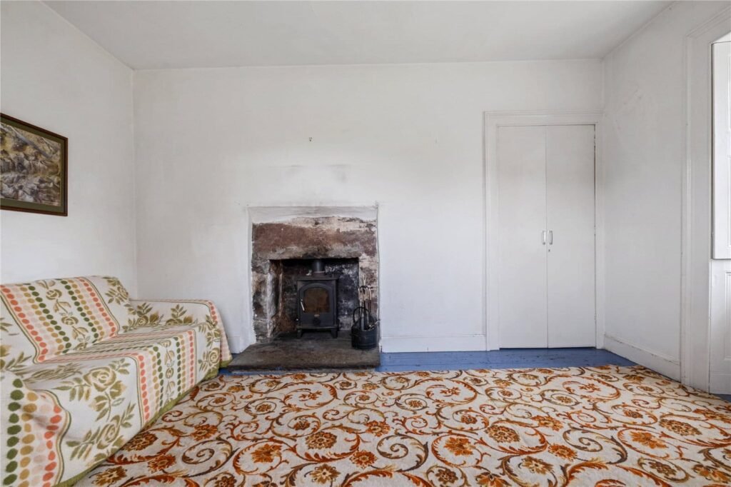 A four-bedroom stone cottage near Loch Torridon is for sale at £550,000, offering nine acres of land, rustic charm, and a private seven-acre island in the Scottish Highlands.