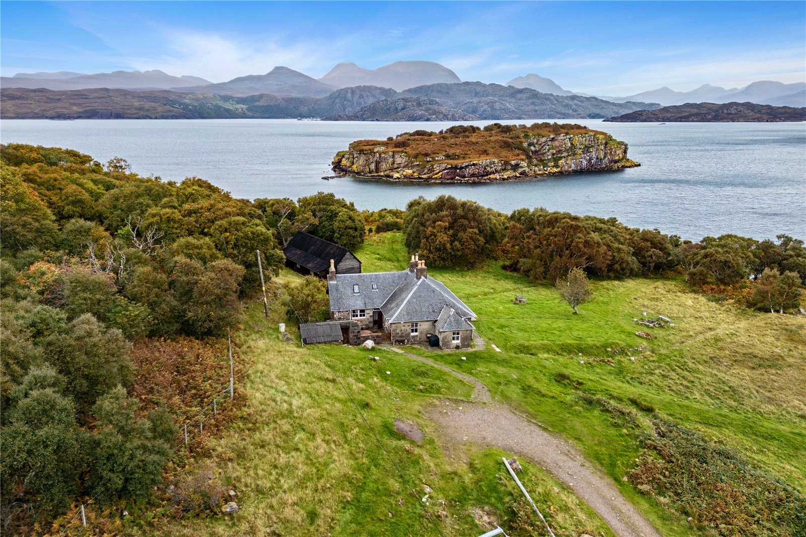 A four-bedroom stone cottage near Loch Torridon is for sale at £550,000, offering nine acres of land, rustic charm, and a private seven-acre island in the Scottish Highlands.