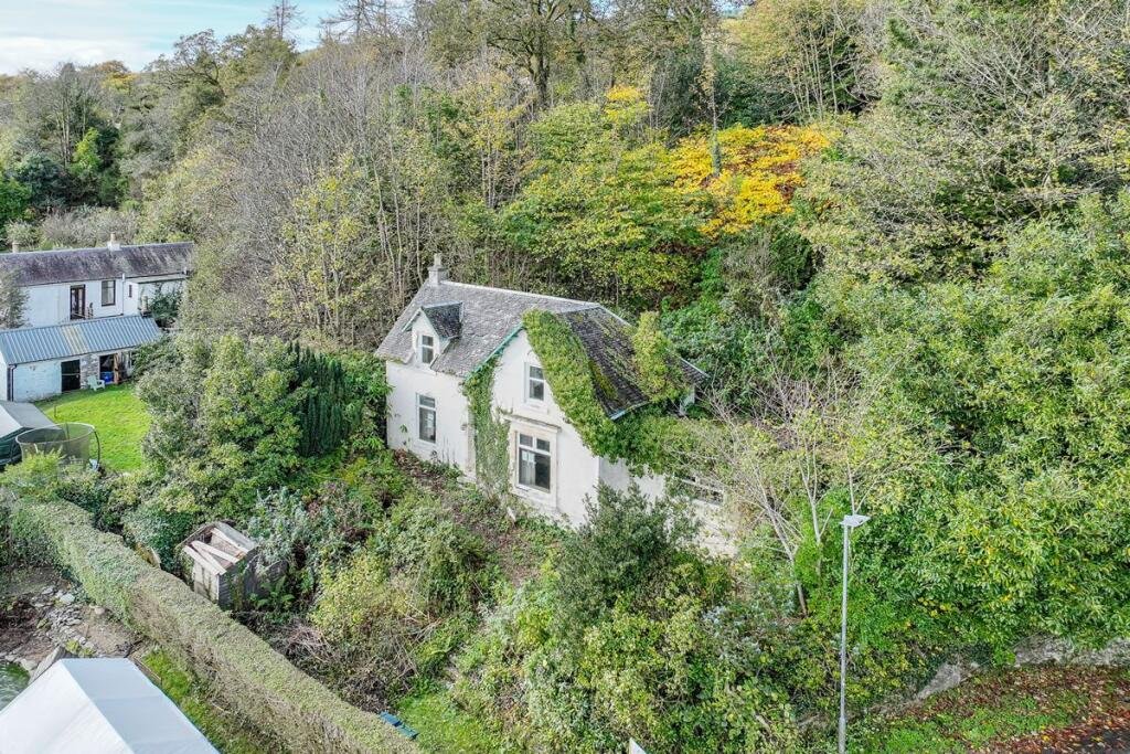 A three-bedroom seaside house near Glasgow is selling for just £60,000, but eerie graffiti reading Help us inside has made this so-called dream home a spooky bargain.