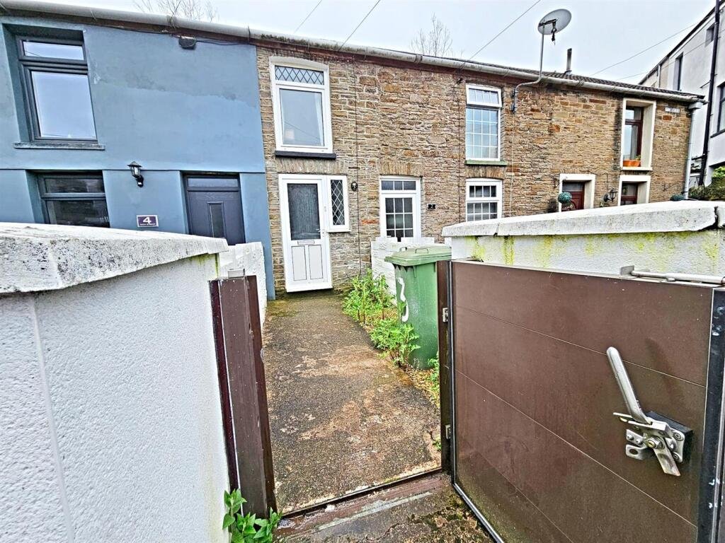 A tiny one-bed house in Pontypridd just five feet wide is on sale for £92,000, featuring a compact open-plan lounge, modern shower room and small front and back gardens.