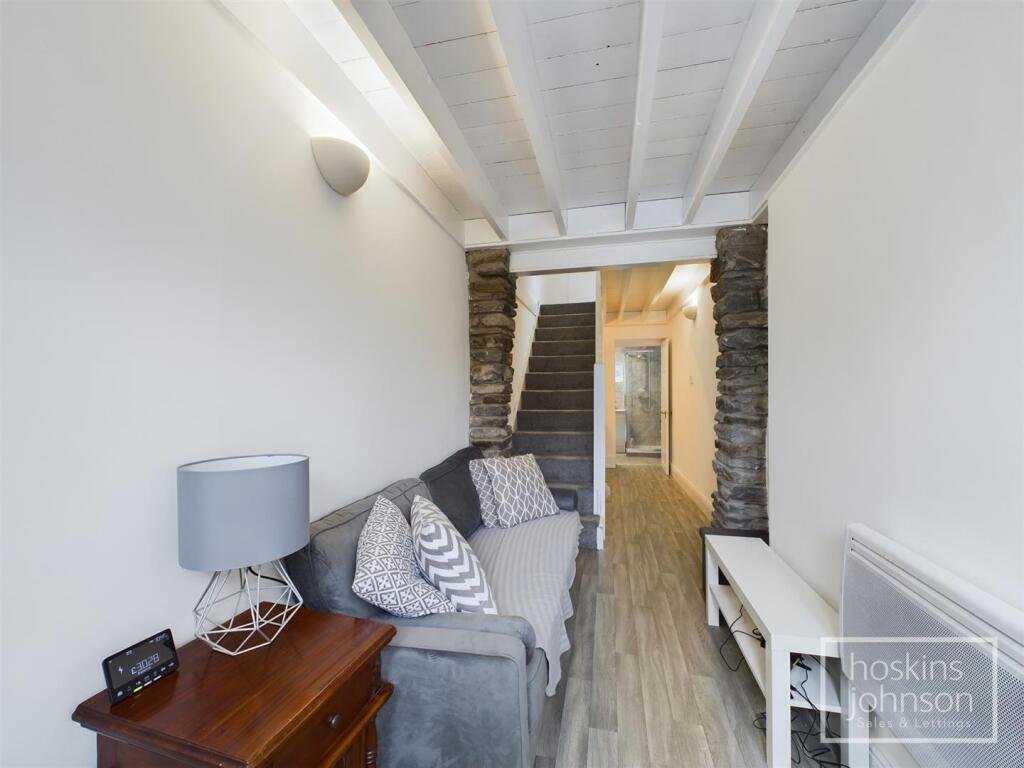 A tiny one-bed house in Pontypridd just five feet wide is on sale for £92,000, featuring a compact open-plan lounge, modern shower room and small front and back gardens.