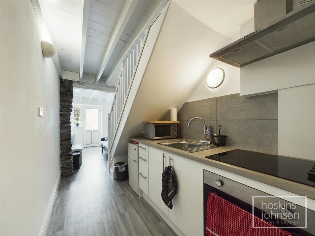 A tiny one-bed house in Pontypridd just five feet wide is on sale for £92,000, featuring a compact open-plan lounge, modern shower room and small front and back gardens.