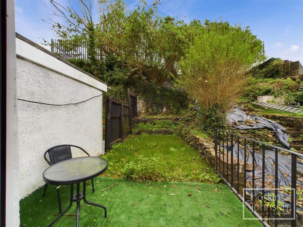 A tiny one-bed house in Pontypridd just five feet wide is on sale for £92,000, featuring a compact open-plan lounge, modern shower room and small front and back gardens.