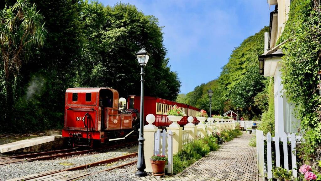 Former Isle of Man steam railway station built in 1874 goes on sale for £750,000, offering four bedrooms, historic charm and steam trains passing just yards away.