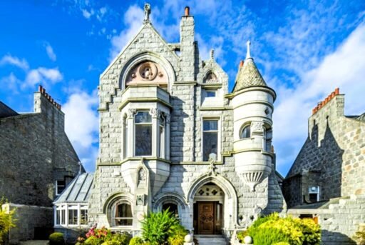 A stunning £1.5m pink granite storybook castle in Aberdeen hits the market offering eight bedrooms grand period details stained glass turrets and lavish interiors in a restored A listed home.