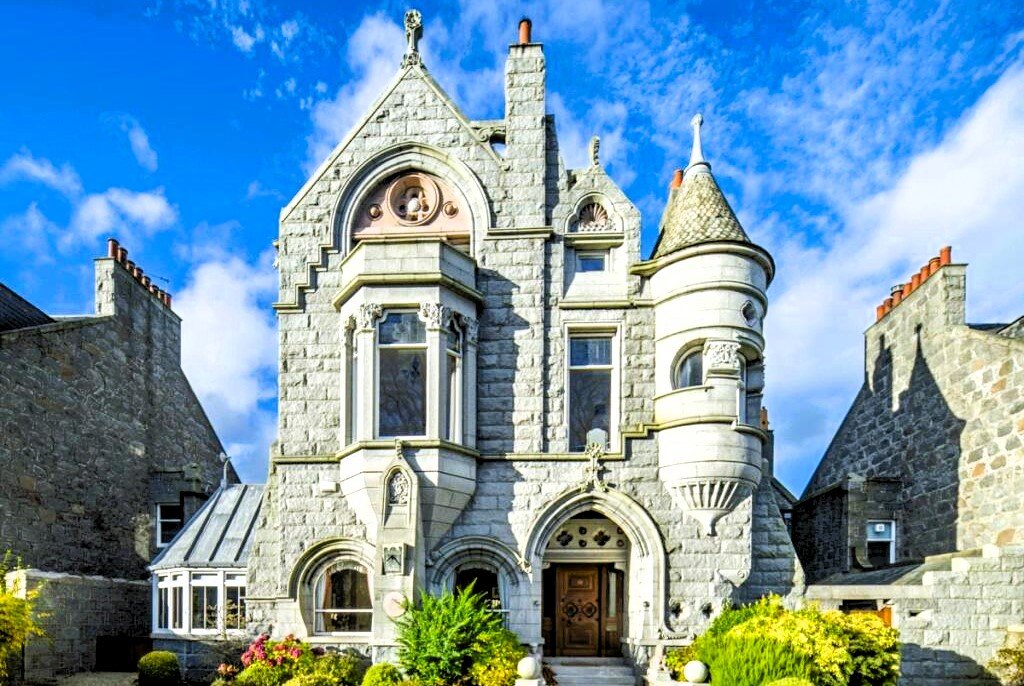 A stunning £1.5m pink granite storybook castle in Aberdeen hits the market offering eight bedrooms grand period details stained glass turrets and lavish interiors in a restored A listed home.