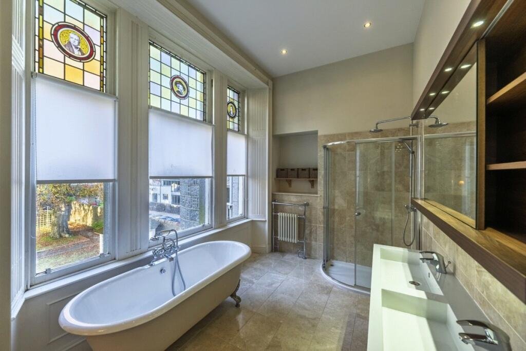 A stunning £1.5m pink granite storybook castle in Aberdeen hits the market offering eight bedrooms grand period details stained glass turrets and lavish interiors in a restored A listed home.