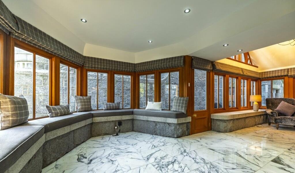 A stunning £1.5m pink granite storybook castle in Aberdeen hits the market offering eight bedrooms grand period details stained glass turrets and lavish interiors in a restored A listed home.