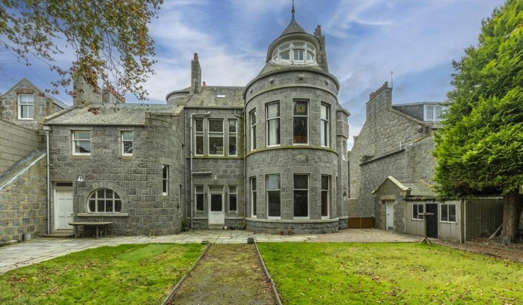 A stunning £1.5m pink granite storybook castle in Aberdeen hits the market offering eight bedrooms grand period details stained glass turrets and lavish interiors in a restored A listed home.