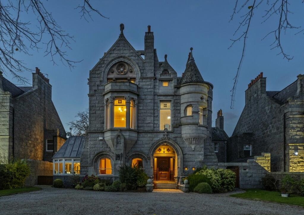 A stunning £1.5m pink granite storybook castle in Aberdeen hits the market offering eight bedrooms grand period details stained glass turrets and lavish interiors in a restored A listed home.