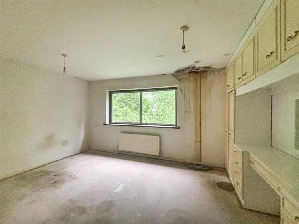 1970s time capsule home hits the market for £255,000, offering five bedrooms, retro charm and huge renovation potential in rural Powys village with gardens and garage for buyers seeking.