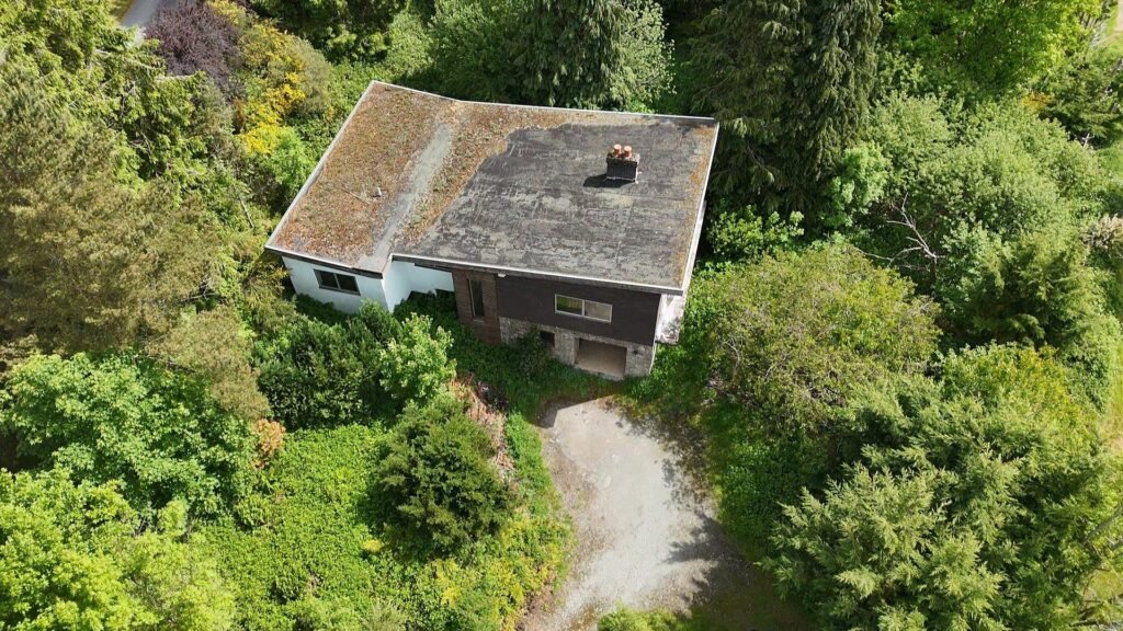1970s time capsule home hits the market for £255,000, offering five bedrooms, retro charm and huge renovation potential in rural Powys village with gardens and garage for buyers seeking.
