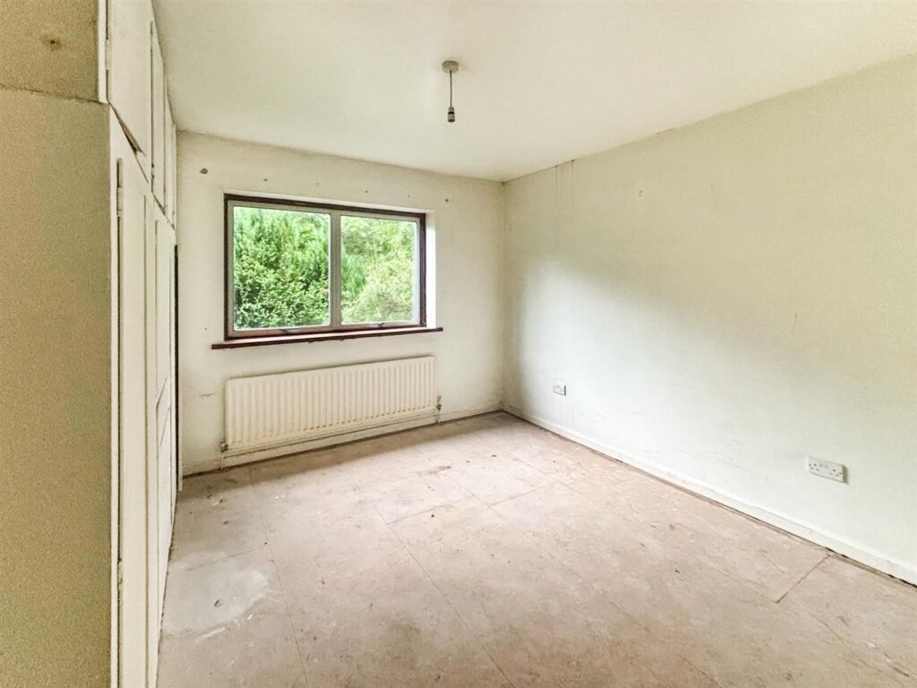 1970s time capsule home hits the market for £255,000, offering five bedrooms, retro charm and huge renovation potential in rural Powys village with gardens and garage for buyers seeking.