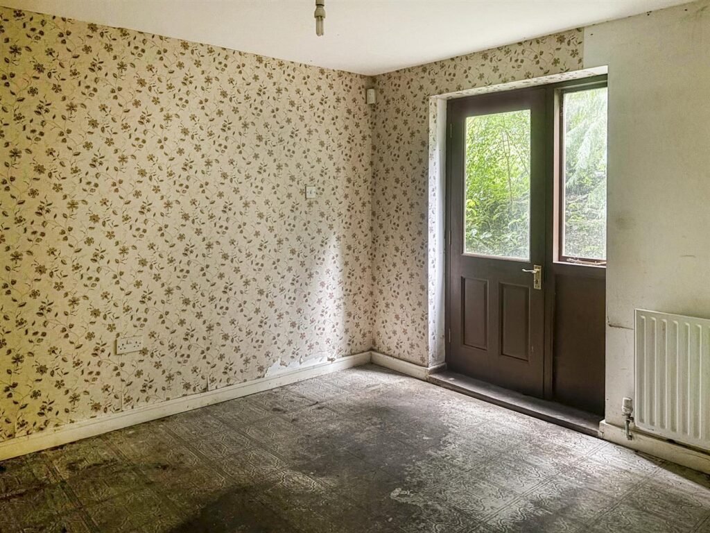 1970s time capsule home hits the market for £255,000, offering five bedrooms, retro charm and huge renovation potential in rural Powys village with gardens and garage for buyers seeking.