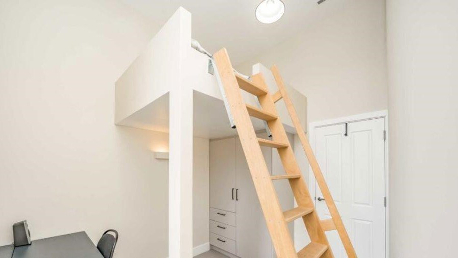 A £450000 London flat sparks attention with steep ladder style beds raised above furniture-offering a quirky space saving layout in a modern Finsbury Park apartment.