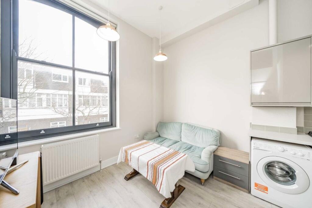 A £450000 London flat sparks attention with steep ladder style beds raised above furniture-offering a quirky space saving layout in a modern Finsbury Park apartment.