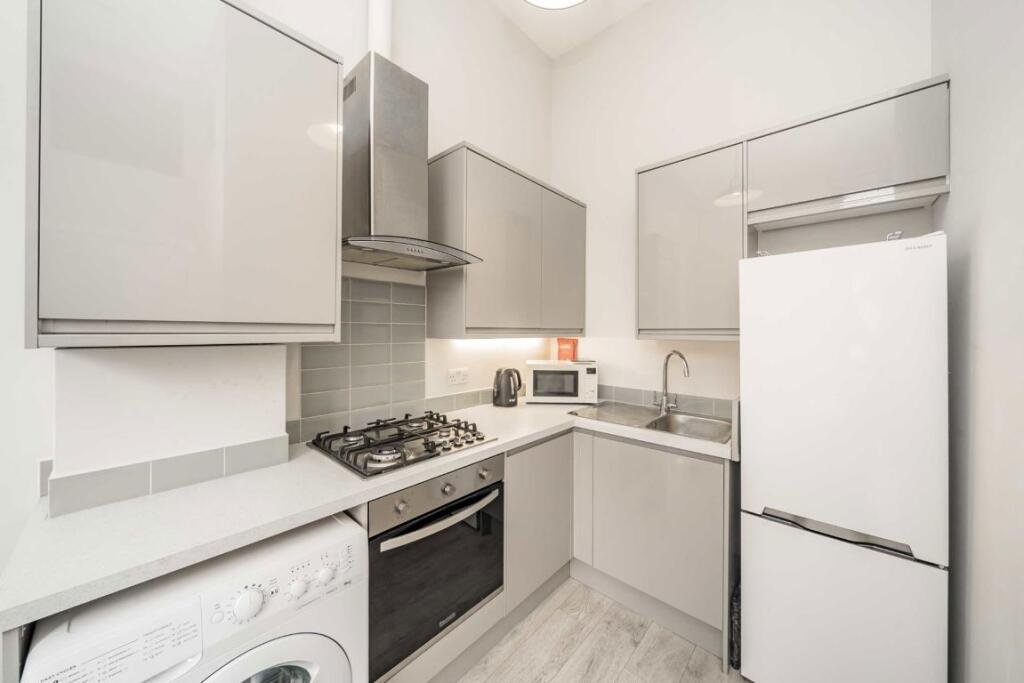 A £450000 London flat sparks attention with steep ladder style beds raised above furniture-offering a quirky space saving layout in a modern Finsbury Park apartment.