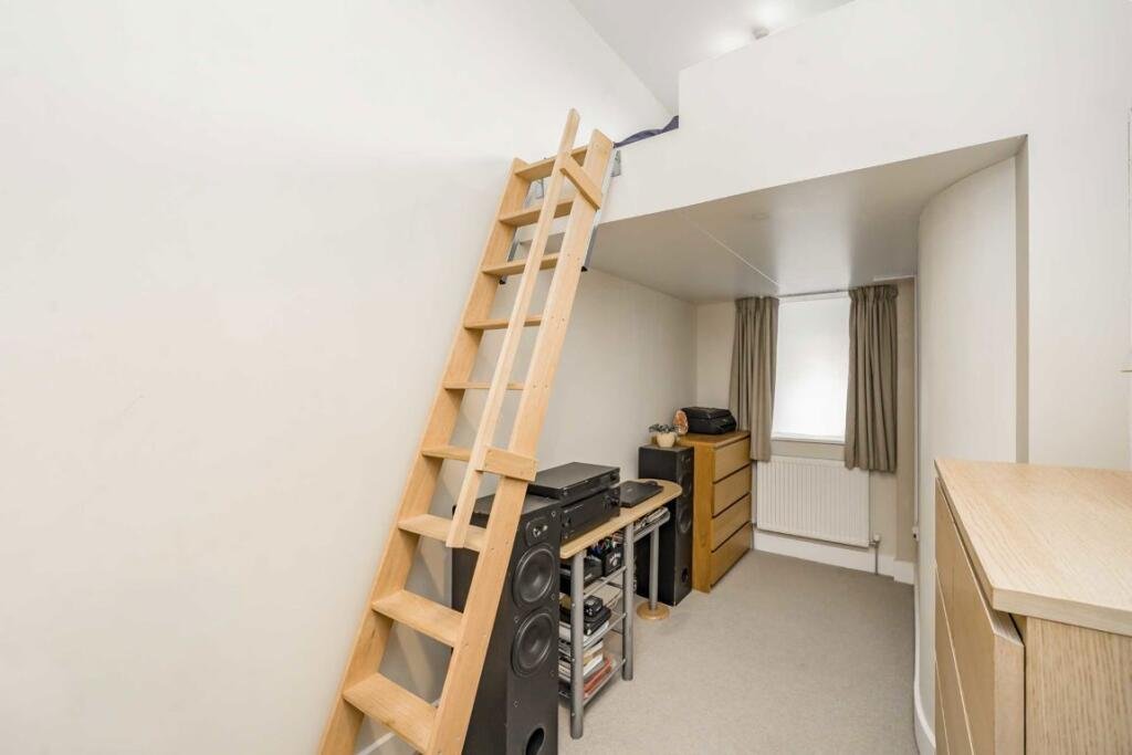 A £450000 London flat sparks attention with steep ladder style beds raised above furniture-offering a quirky space saving layout in a modern Finsbury Park apartment.