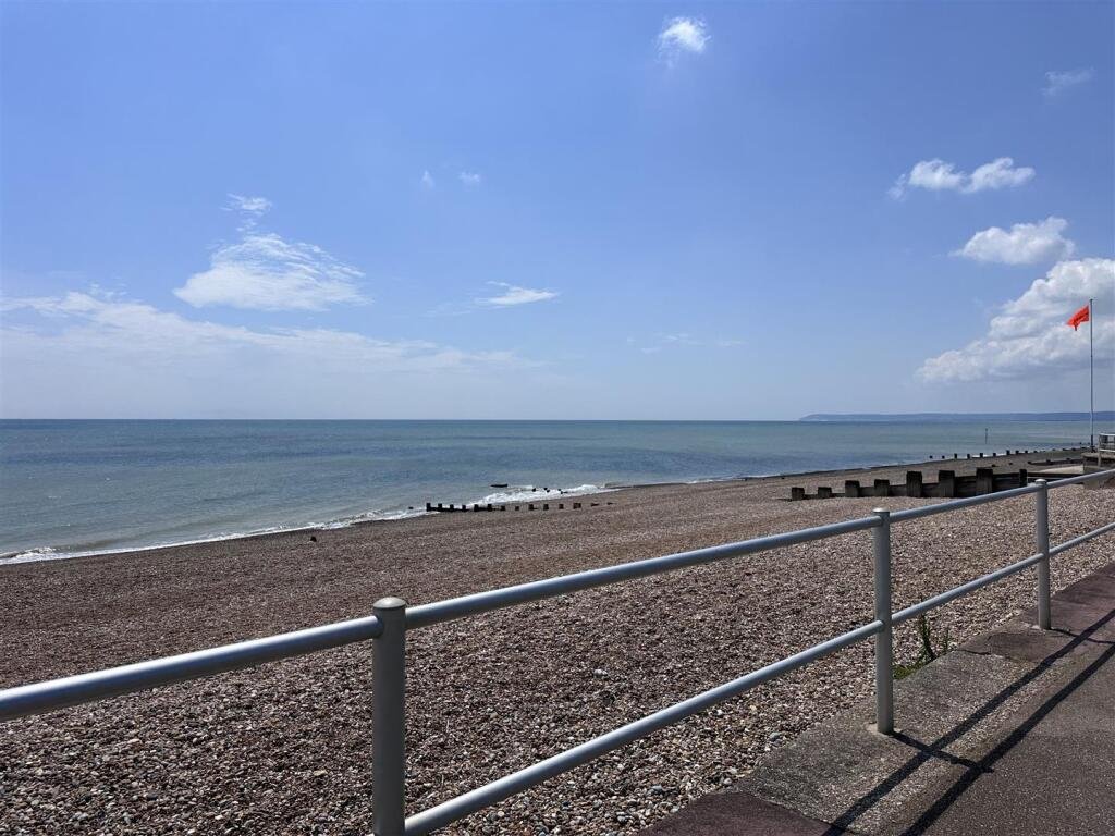 A £1,200-a-month seaside flat with a sink beside the bed has gone viral, leaving renters baffled by the quirky layout, high deposit, and income requirements.