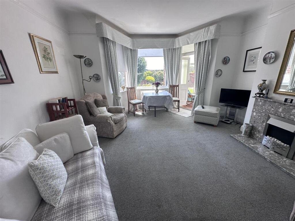 A £1,200-a-month seaside flat with a sink beside the bed has gone viral, leaving renters baffled by the quirky layout, high deposit, and income requirements.