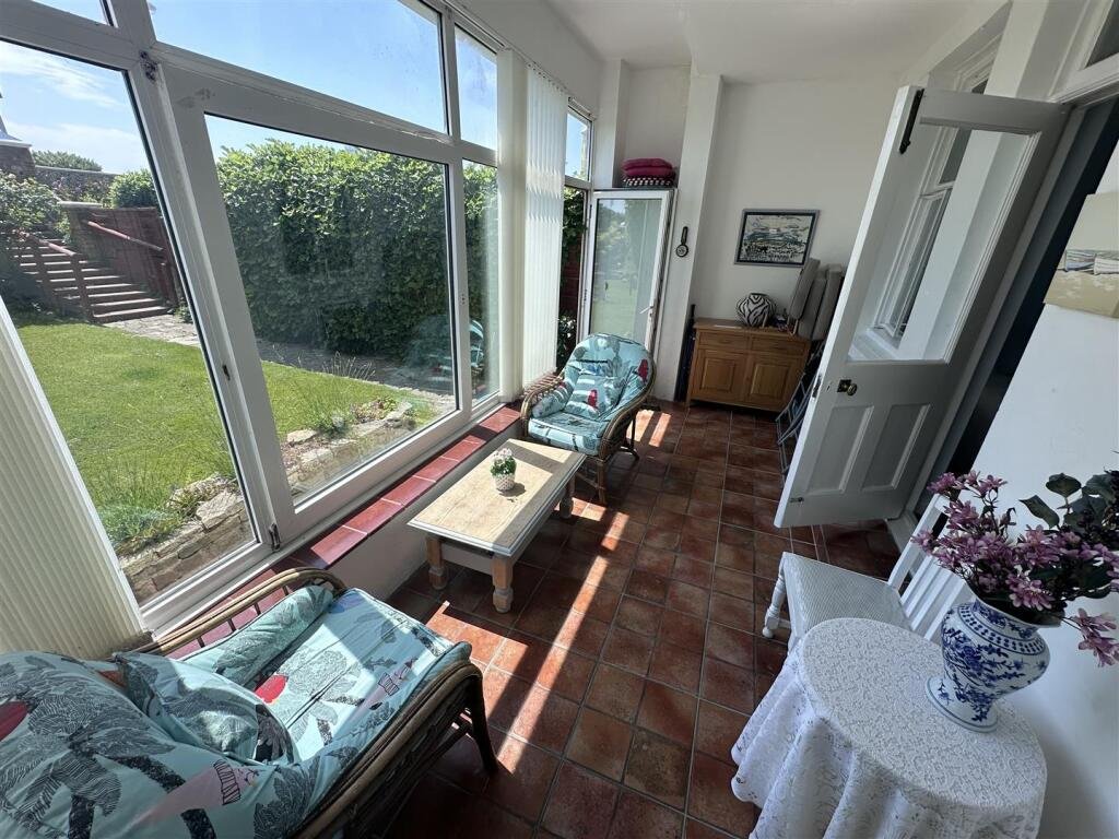 A £1,200-a-month seaside flat with a sink beside the bed has gone viral, leaving renters baffled by the quirky layout, high deposit, and income requirements.