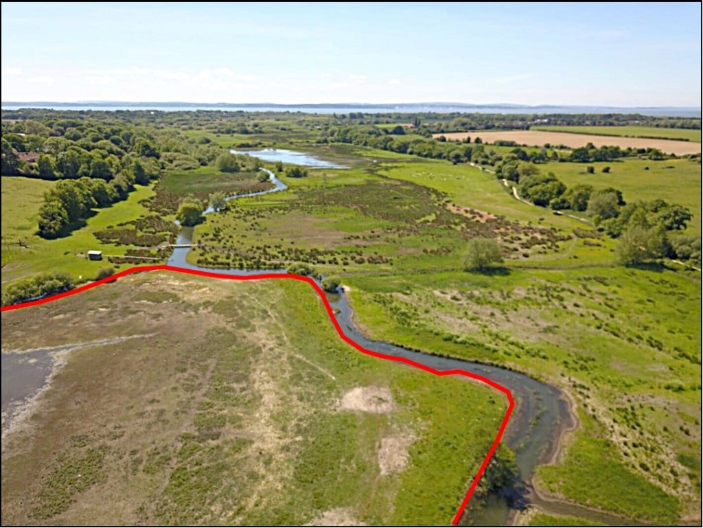 Six acres of flood-prone land beside the River Meon is for sale at £250,000, with buyers warned to bring waders as much of the soggy field sits underwater each winter no.