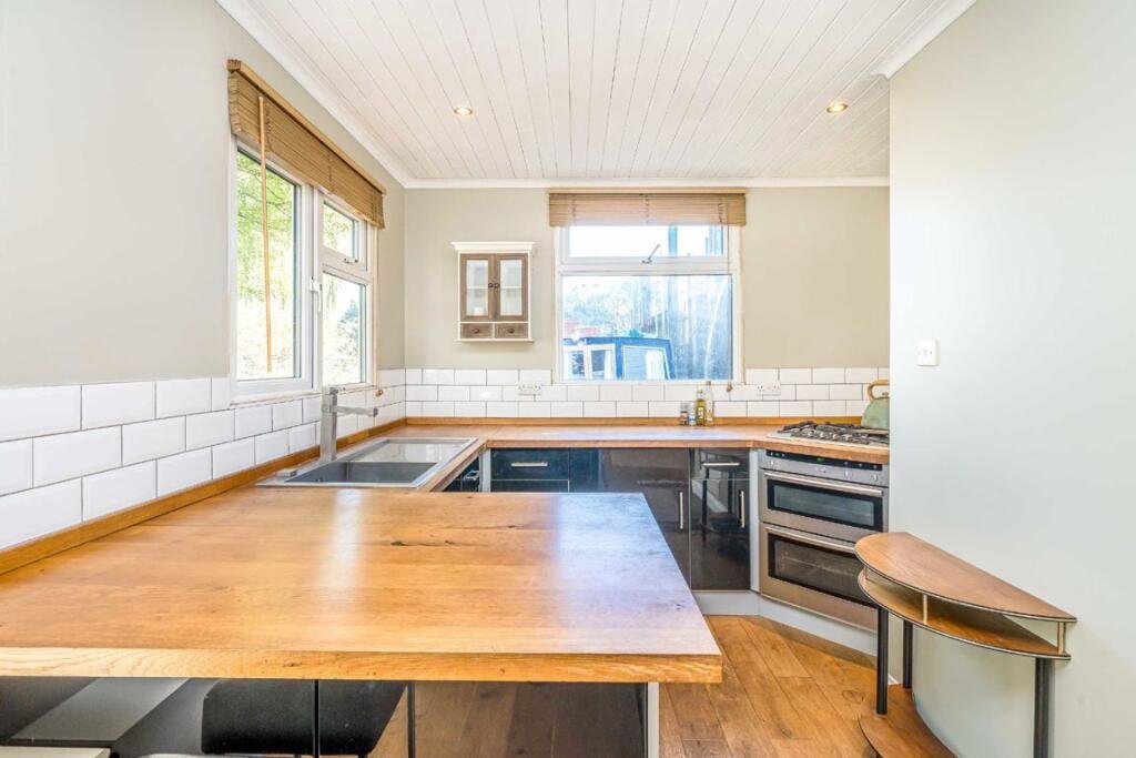 Quirky floating caravan turned houseboat hits the Thames market for £99,950, offering one bedroom, log burner, roof seating and full-time riverside living