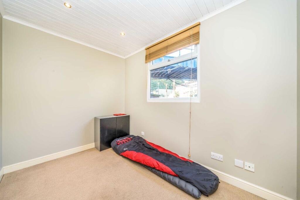 Quirky floating caravan turned houseboat hits the Thames market for £99,950, offering one bedroom, log burner, roof seating and full-time riverside living