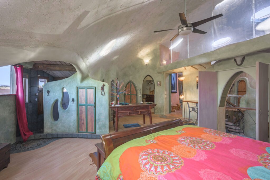 A whimsical pink dome home inspired by rainforests and desert landscapes has gone on sale for £1.2m, offering eco luxury, yoga domes and magical interiors in New Mexico