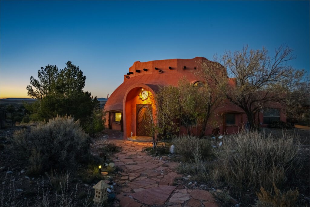 A whimsical pink dome home inspired by rainforests and desert landscapes has gone on sale for £1.2m, offering eco luxury, yoga domes and magical interiors in New Mexico