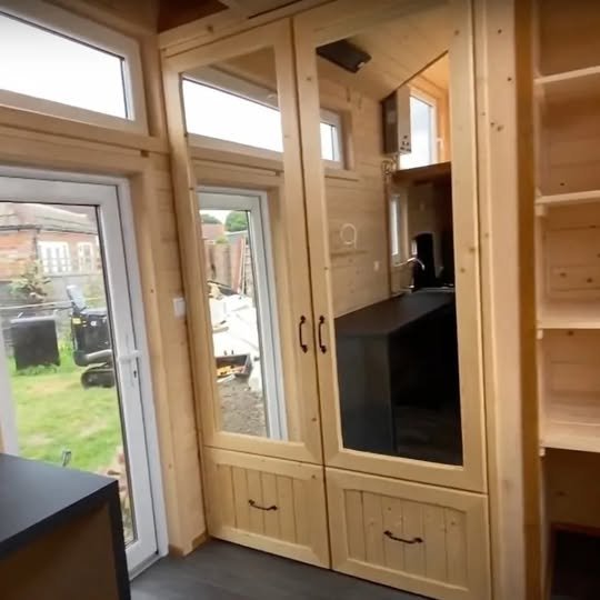Off grid ready tiny all wood home with ultra low running costs goes on sale for £24,500 in London, featuring kitchen, bathroom, water tank and multiple living uses.