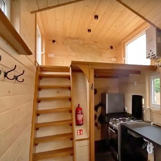 Off grid ready tiny all wood home with ultra low running costs goes on sale for £24,500 in London, featuring kitchen, bathroom, water tank and multiple living uses.